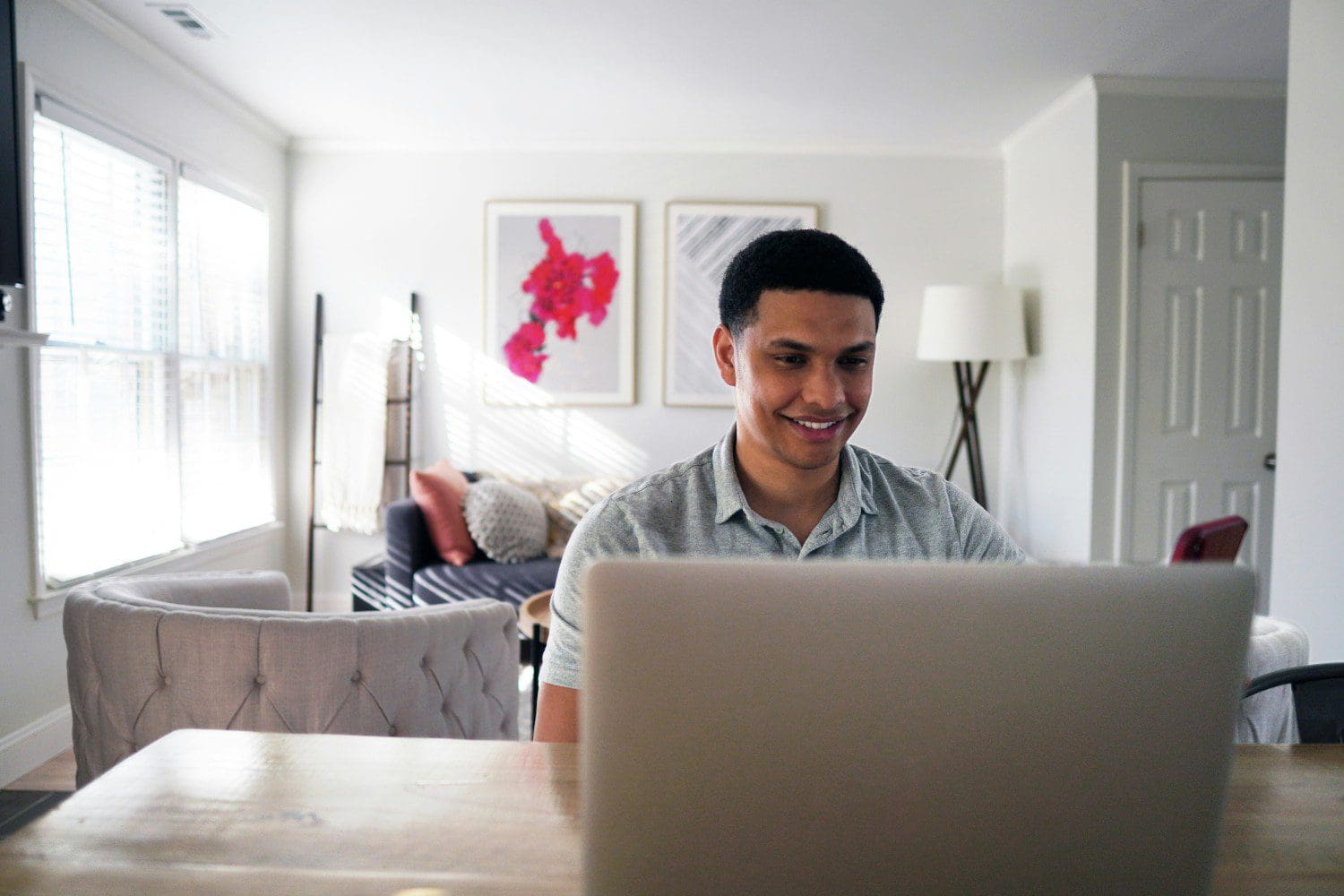 A man sitting at a table with a laptop.